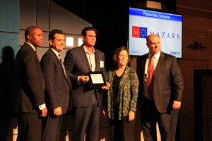 Aspire's President & CEO accepts a plaque from NJBIZ for ranking number 26 on NJBIZ's 2017 Fast 50