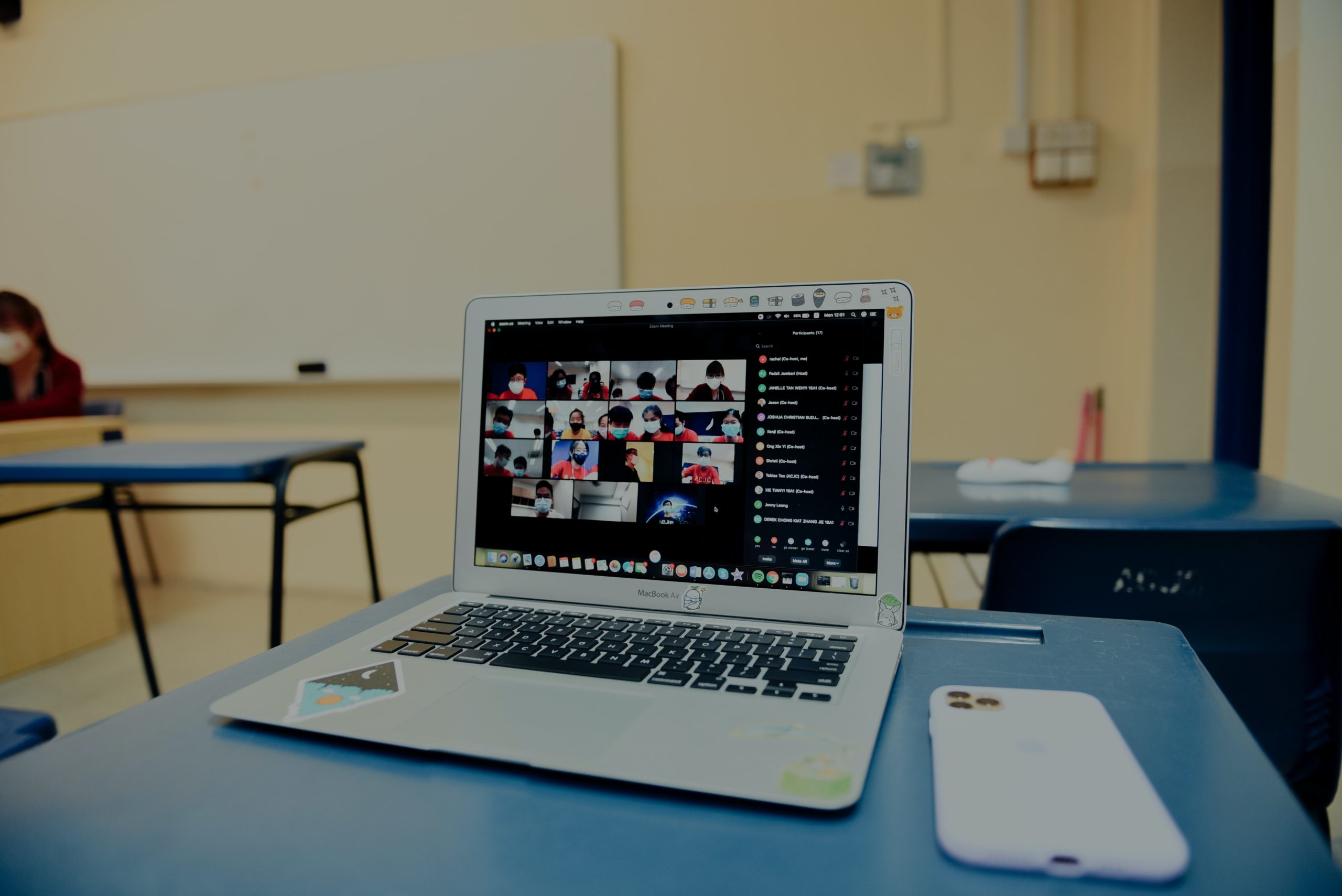 Students appear on video on a laptop in a school classroom