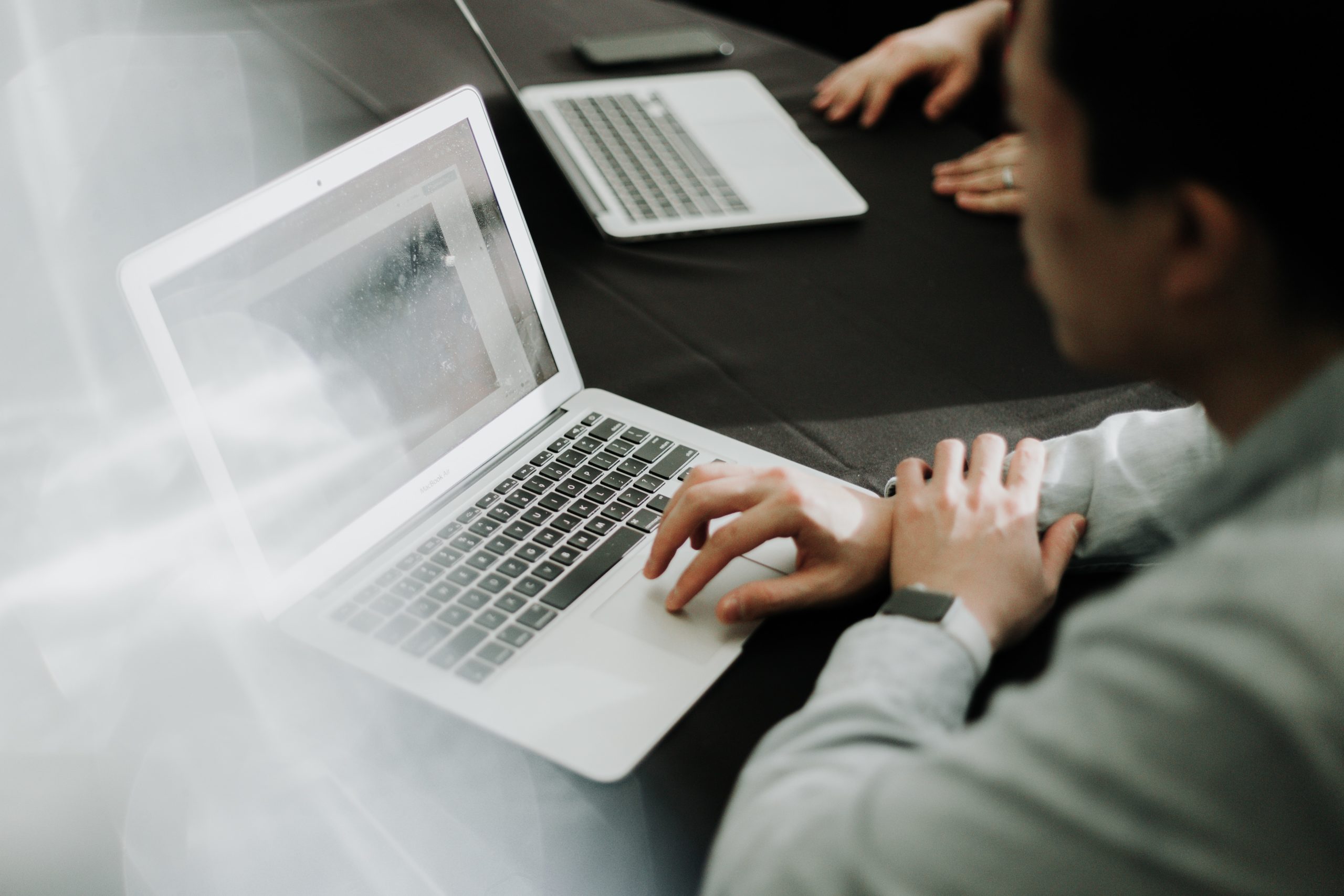 A man prepares a data management strategy while working on a laptop